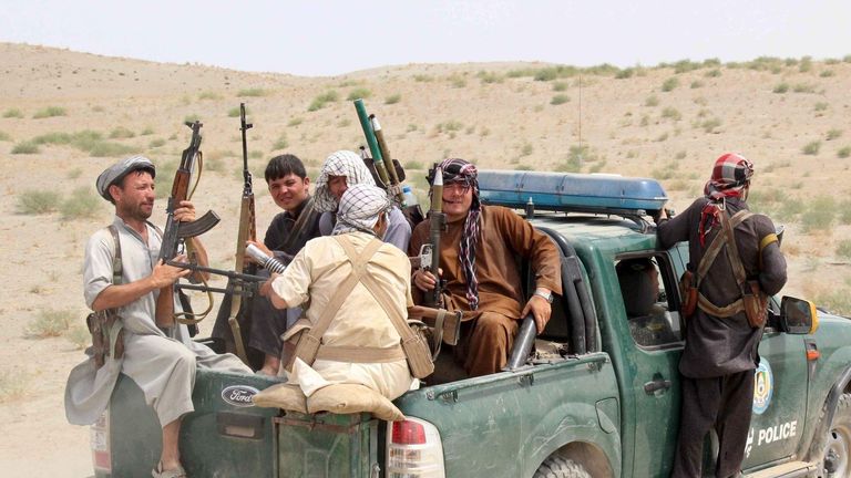 Afghan local police (ALP) sit at the back of a truck near a frontline during a battle with the Taliban at Qalay- i-zal district, in Kunduz province, Afghanistan