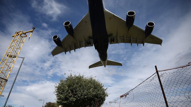Plane lands at Heathrow airport as debate over third runway continues