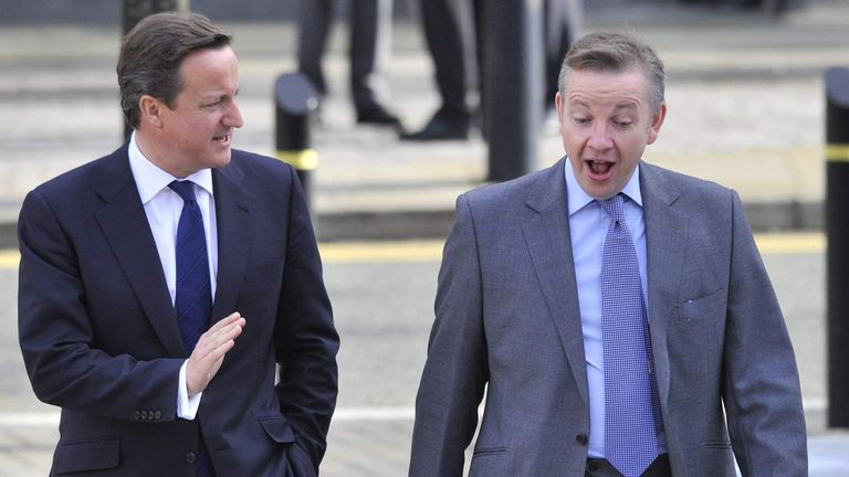 Britain's Prime Minister Cameron and Education Secretary Gove walk to the conference halls on the third day of the Conservative Party's annual Conference in Manchester