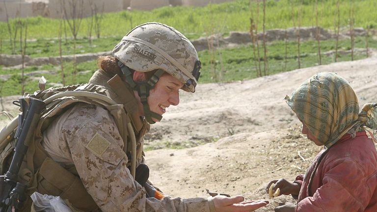 U.S. Marine Corps handout photo of Lt. Johanna Shaffer sharing a cookie with an Afghan child in Farah Province
