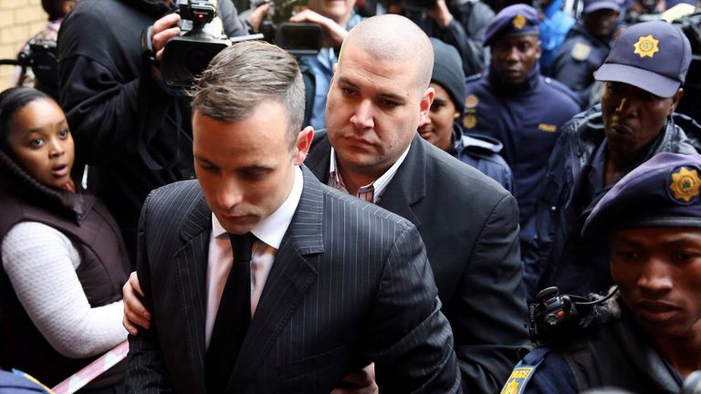Former Paralympian Oscar Pistorius arrives to be sentenced for murder of his girlfriend Reeva Steenkamp at the Pretoria High Court