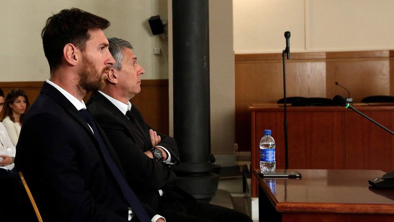 Barcelona's Argentine soccer player Lionel Messi sits in court with his father Jorge Horacio Messi during their  trial for tax fraud in Barcelona