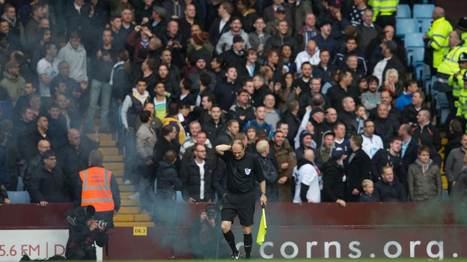 Linesman Hit By Flare During Spurs-villa Match 