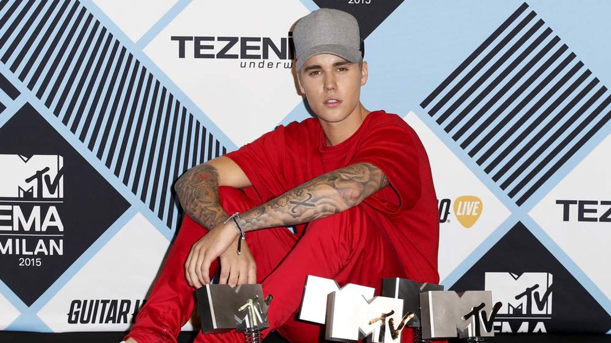 Canadian singer <b>Bieber</b> poses with his awards during the <b>MTV</b> EMA awards at t...