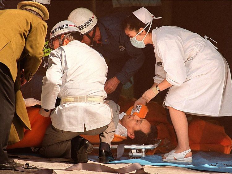 A commuter is treated outside a station in Tokyo after a sarin gas attack in 1995