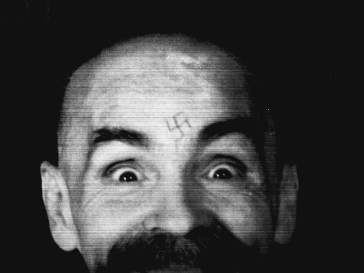 Charles Manson photographed in 1989 as he is led to his cell after an interview with Reuters