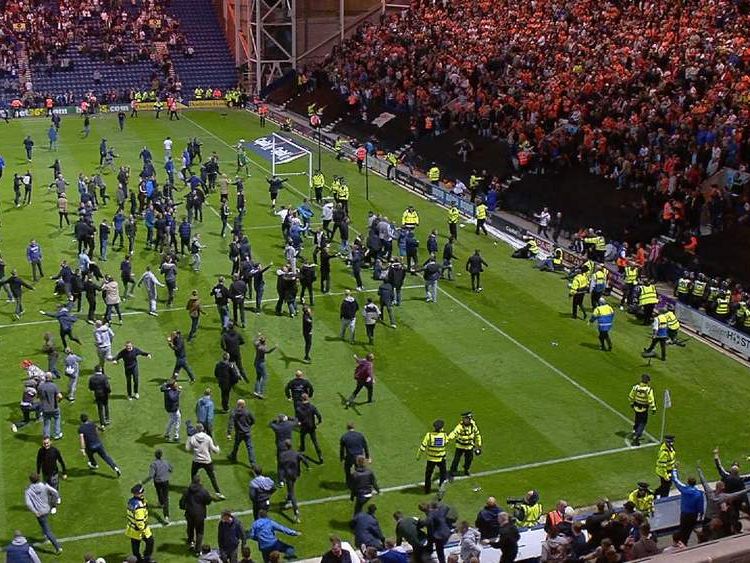 Football Steward Trampled In Pitch Invasion