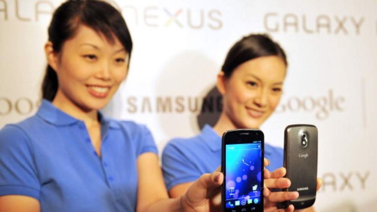 Models pose with the new Samsung Galaxy Nexus Android phone during its official launch in Hong Kong in October 2011