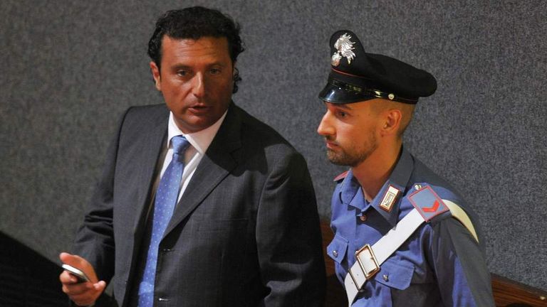 Costa Concordia's captain Francesco Schettino speaks with a policeman