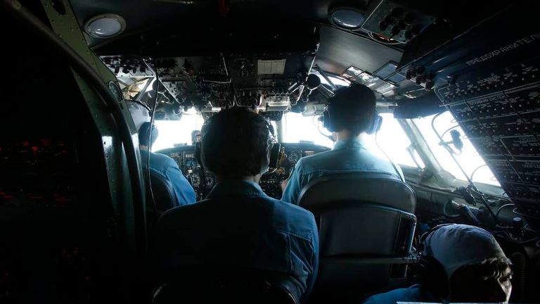Military officers work within the cockpit of an aircraft belonging to the Vietnamese airforce during a search and rescue mission off Vietnam's Tho Chu island