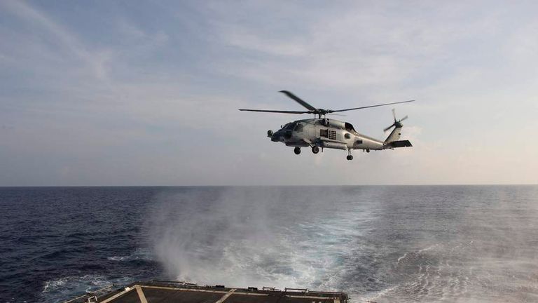 Handout picture of A U.S. Navy SH-60R Seahawk helicopter takes off from the destroyer USS Pinckney in the Gulf of Thailand, to assist in the search for missing Malaysian Airlines flight MH370