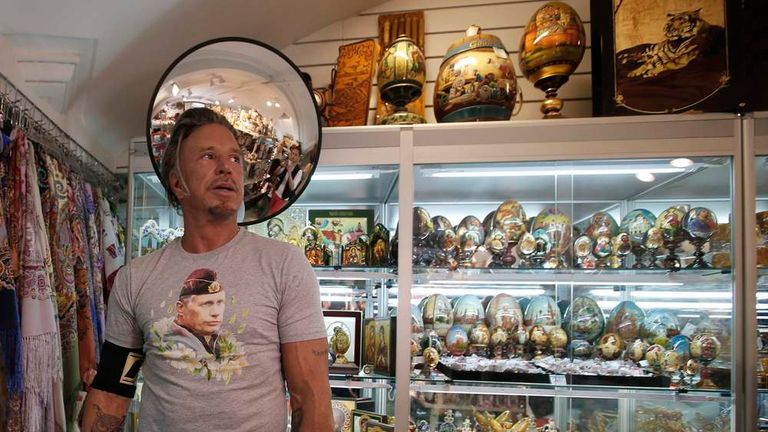 Actor Rourke wears a T-shirt with an image depicting Russia's President Vladimir Putin, as he visits a souvenir shop at GUM department store in central Moscow