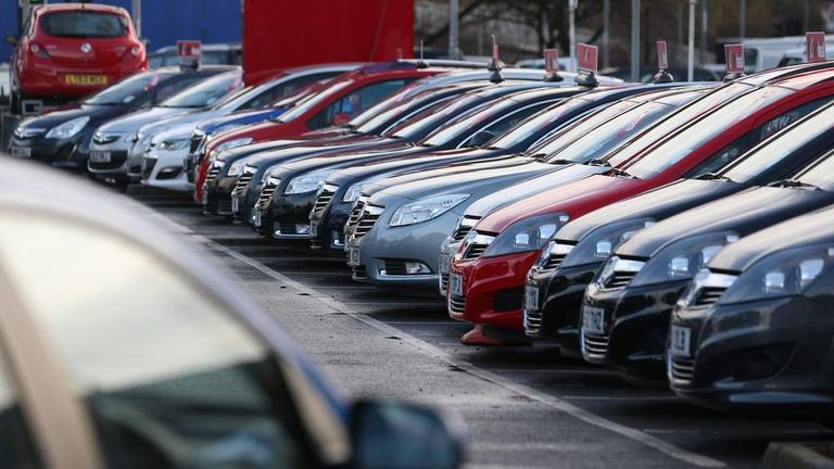 Cars displayed for sale on the forecourt of a dealership in London.