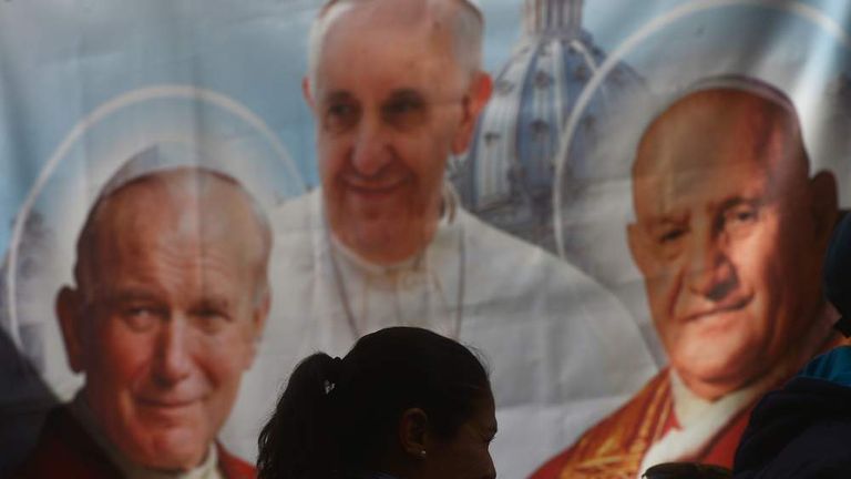 A poster shows the late Popes John XXIII and John Paul II ahead of their canonisation.