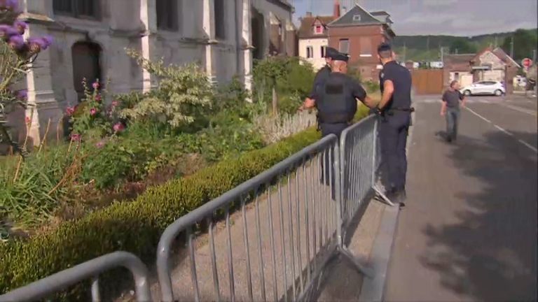Sky&#39;s Nick Martin walks around the church in Normandy where the priest was killed