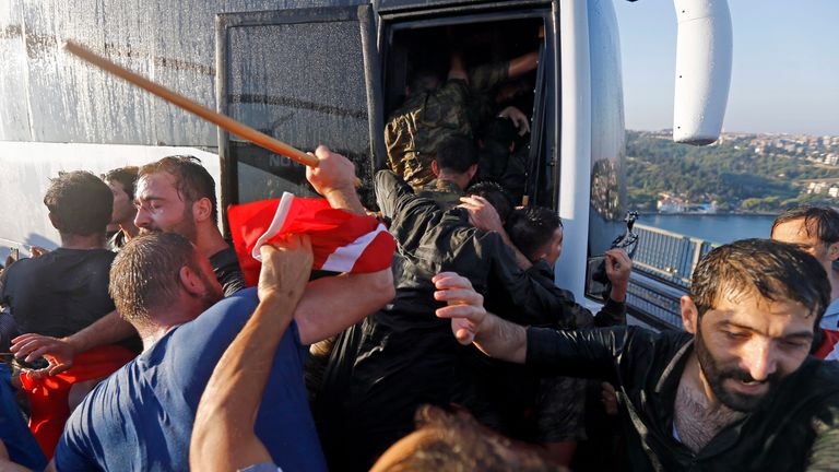 Soldiers push each other to board a bus to escape the mob after troops involved in the coup surrendered on the Bosphorus Bridge in Istanbul.