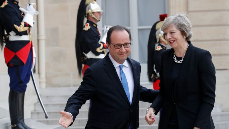 French President Francois Hollande (L) greets Britain&#39;s Prime Minister Theresa May at the Elysee Palace in Paris, France