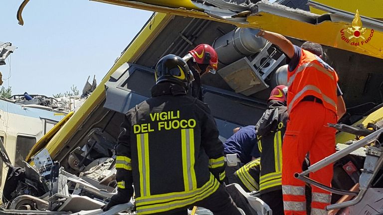Rescue workers trying to get inside the badly damaged carriages