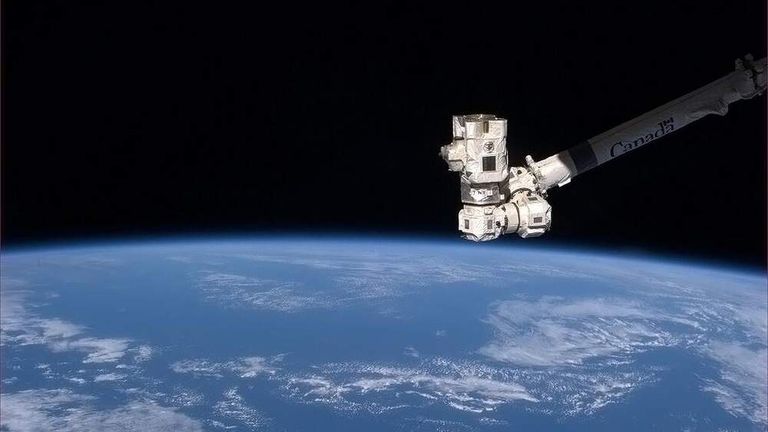Canadarm2 gives a thumbs-up to the World.