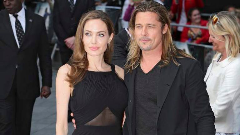 Angelina Jolie poses with her husband Brad Pitt as they arrive for the world premiere of his film World War Z in London