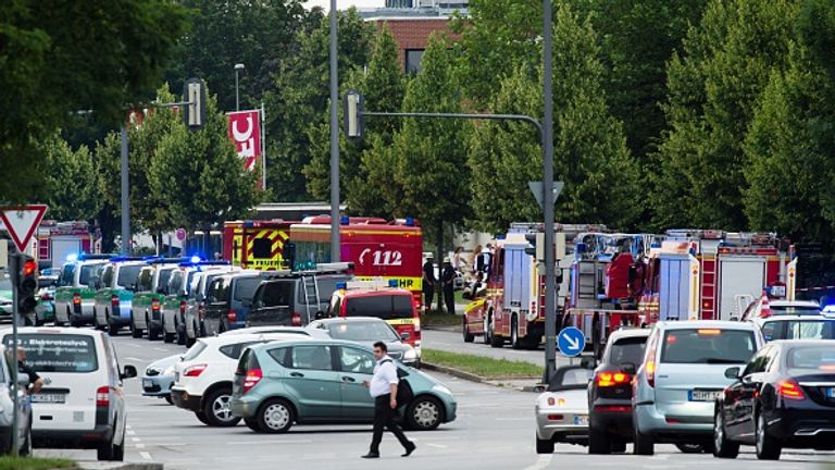 Police and firefighters are seen near a shopping centre in Munich, not far from the city&#39;s Olympic Stadium