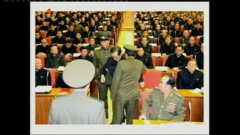NORTH KOREAN SOLDIERS TAKING JANG SONG THAEK from ruling workers' party meeting