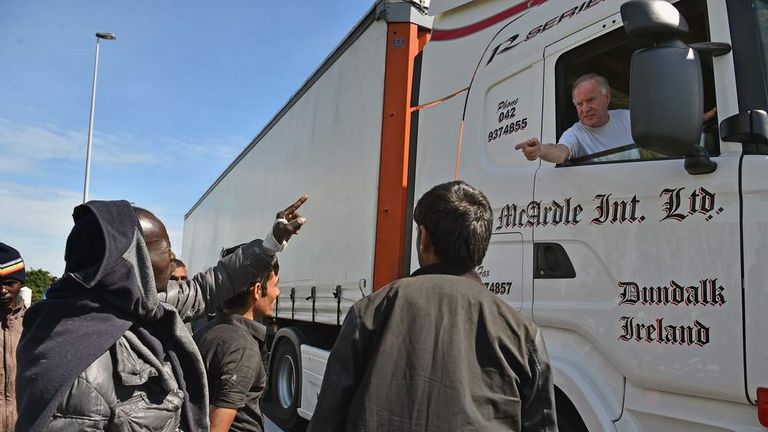 Migrants attempt to board a lorry heading into the UK.