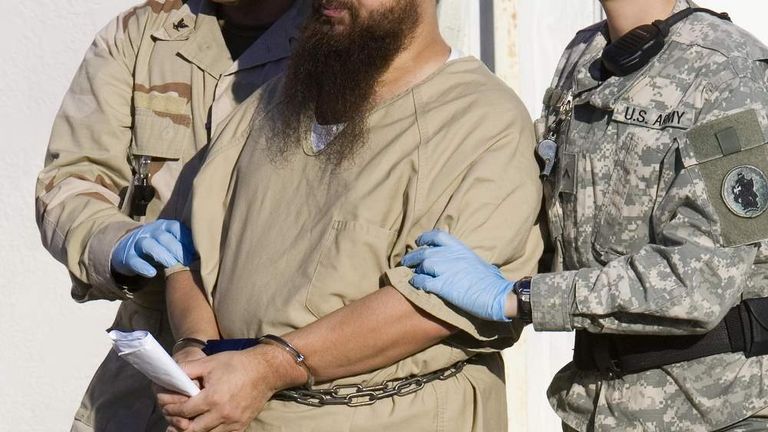 A detainee is escorted by guards at Guantanamo Bay, Cuba