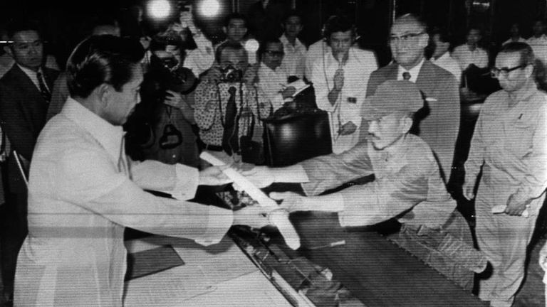 Hiroo Onoda surrenders his sword to Philippine president Ferdinand Marcos