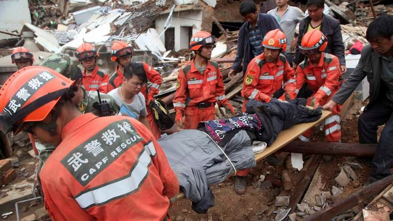 Rescue workers evacuate an injured person after a magnitude 6.3 ...