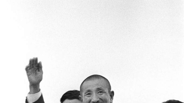 Former Japanese imperial army soldier Hiroo Onoda (C) waving upon his return home