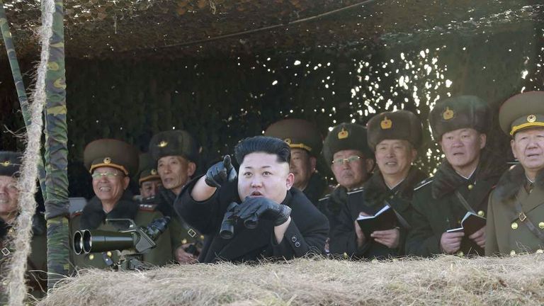 North Korean leader Kim Jong Un (front) watches a drill by the Korean People's Army