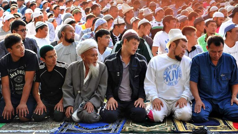 Kyrgyz muslims pray on the first day of Eid al-Fitr at a square in central Bishkek
