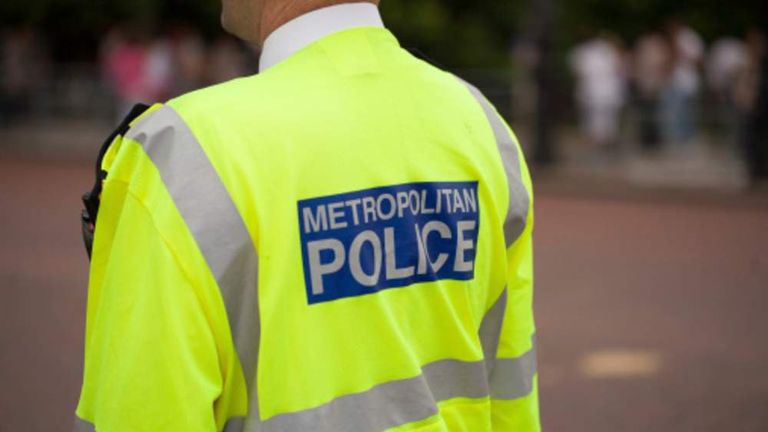 A picture showing the back of a policeman with a Metropolitan Police sign on his back
