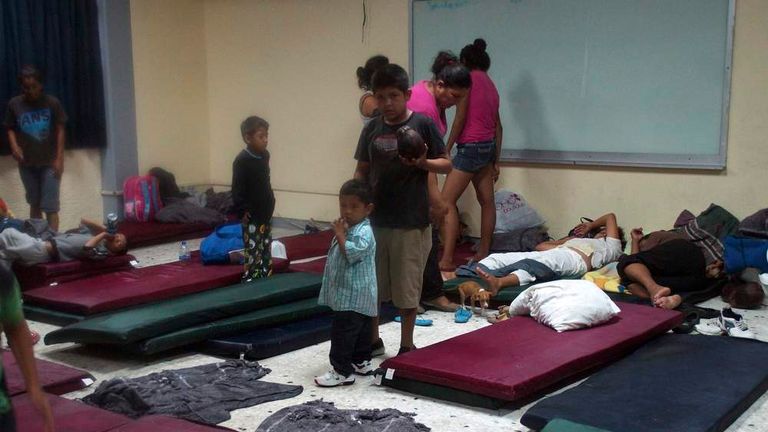 Residents wait at a makeshift shelter after Hurricane Odile