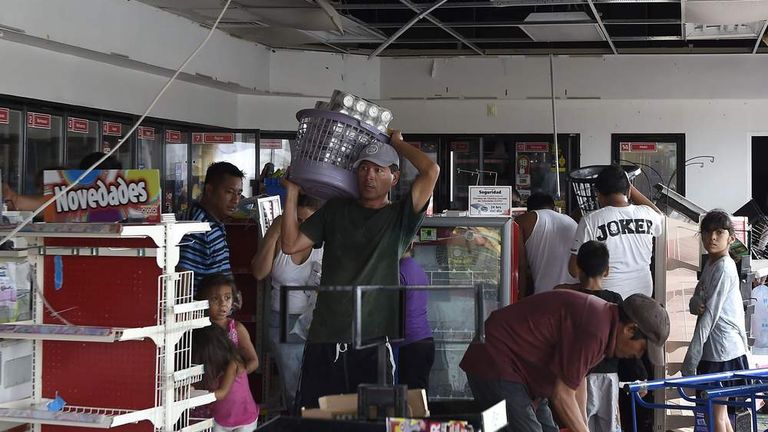 People loot a supermarket in Cabo San Lucas after Hurricane Odile