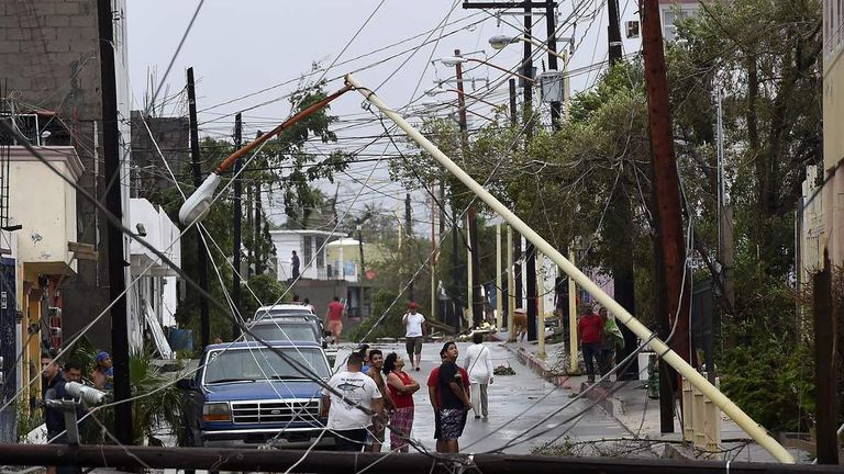People look at the destruction after Hurricane Odile
