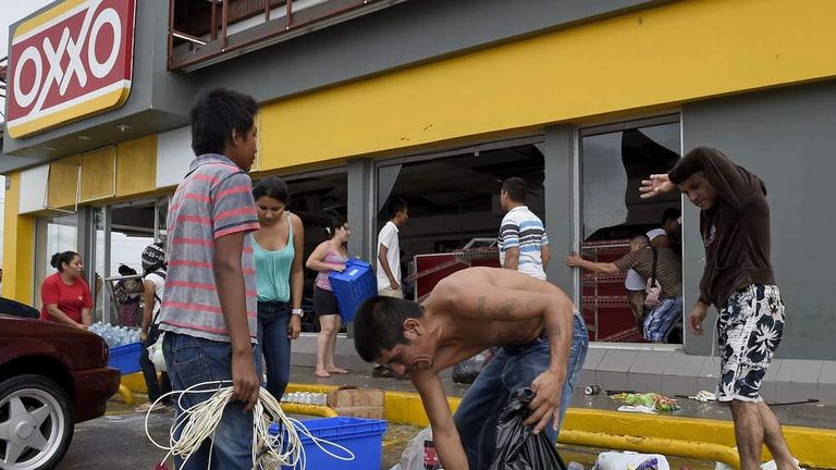 People loot a supermarket in Cabo San Lucas Hurricane Odile