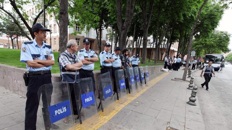 Police officers standing outside a building during a protest in Turkey.