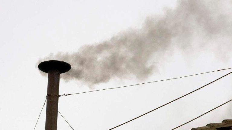 Black smoke is seen from the roof of the Sistine Chapel