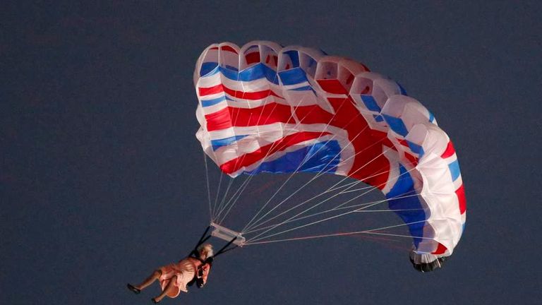 Performer plays role of Queen parachuting from helicopter into Olympic Stadium