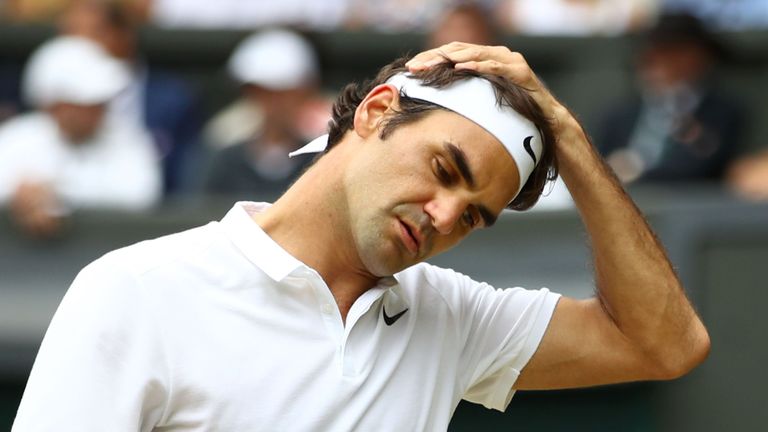 Switzerland's Roger Federer reacts after losing a point to Canada's Milos Raonic