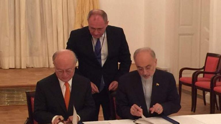 Hassan Rouhani signs the agreement with the IAEA