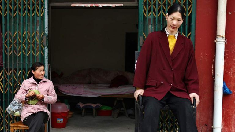 Tallest woman in Asia and her friend sit in Shu Cha in eastern China's Anhui province