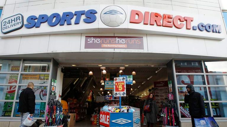 Shoppers wait outside a branch of Sports Direct in Brighton southern England