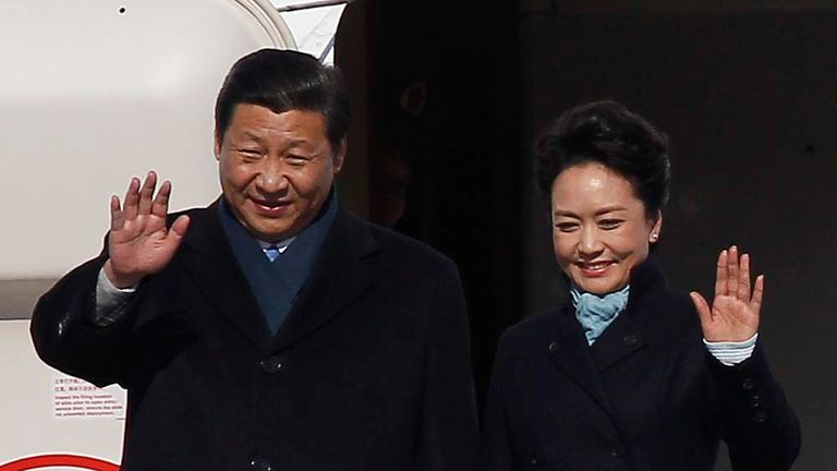 Chinese President Xi and First Lady Peng wave as they arrive at Moscow's Vnukovo airport