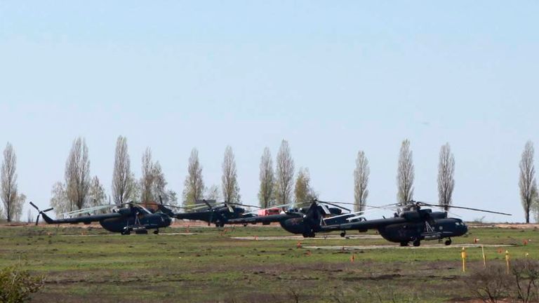Russian military helicopters are seen in a field outside the village of Severny in Belgorod region near the Russian-Ukrainian border.