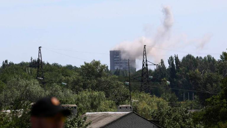 Smoke rises above a damaged multi-storey block of flats following what locals say was shelling by Ukrainian forces in Shakhtarsk, Donetsk region