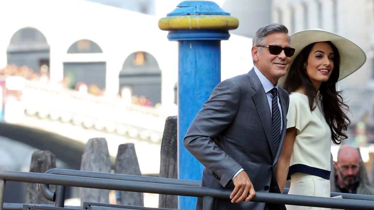U.S. actor George Clooney and his wife Amal Alamuddin arrive at Venice city hall for a civil ceremony to formalize their wedding in Venice