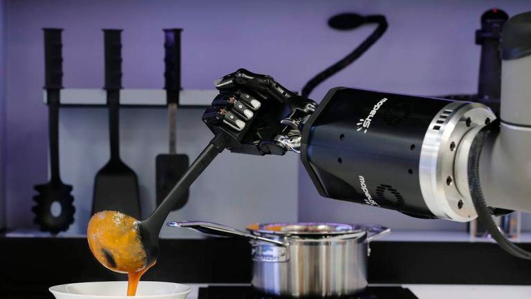 A robot in the Robotic Kitchen prototype created by Moley Robotics cooks a crab soup at the company's booth at the world's largest industrial technology fair, the Hannover Messe, in Hanover